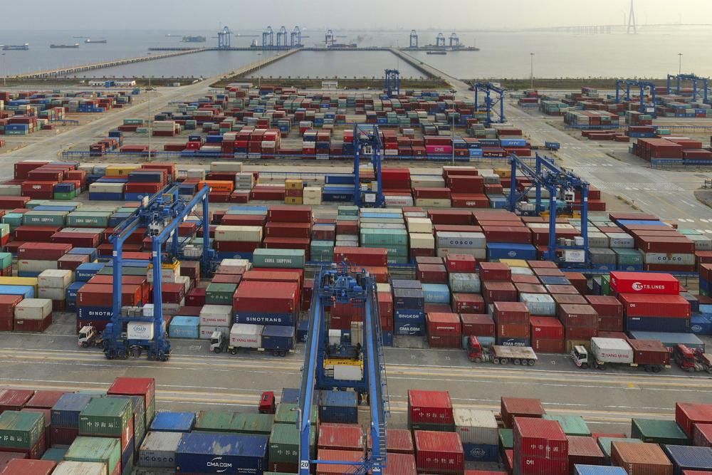 FILE - In this April 8, 2021, file photo, a container port on the Yangtze River is seen in an aerial view in Nantong in eastern China's Jiangsu province. China's exports surged nearly 28% in May 2021 while imports jumped 51% as demand rebounded in the U.S. and other markets where the pandemic is waning, though growth is leveling off after a stunning recovery from last year's slump. (Chinatopix via AP, File)