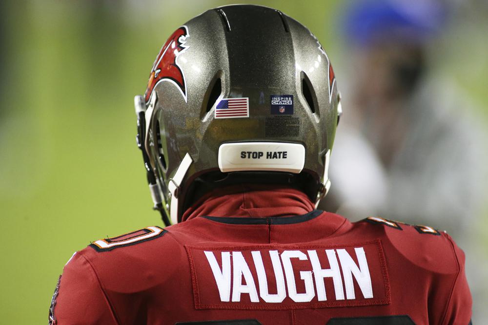 FILE - In this Jan. 9, 2021, file photo, Tampa Bay Buccaneers running back Ke'Shawn Vaughn wears a helmet with the message "Stop Hate" before the team's NFL wild-card playoff football game against the Washington Football Team in Landover, Md. NFL players can wear social justice messages on their helmets again this season and “It Takes All of Us” and “End Racism” will be stenciled in end zones for the second straight year as part of the league’s Inspire Change platform. (AP Photo/Daniel Kucin Jr., File)