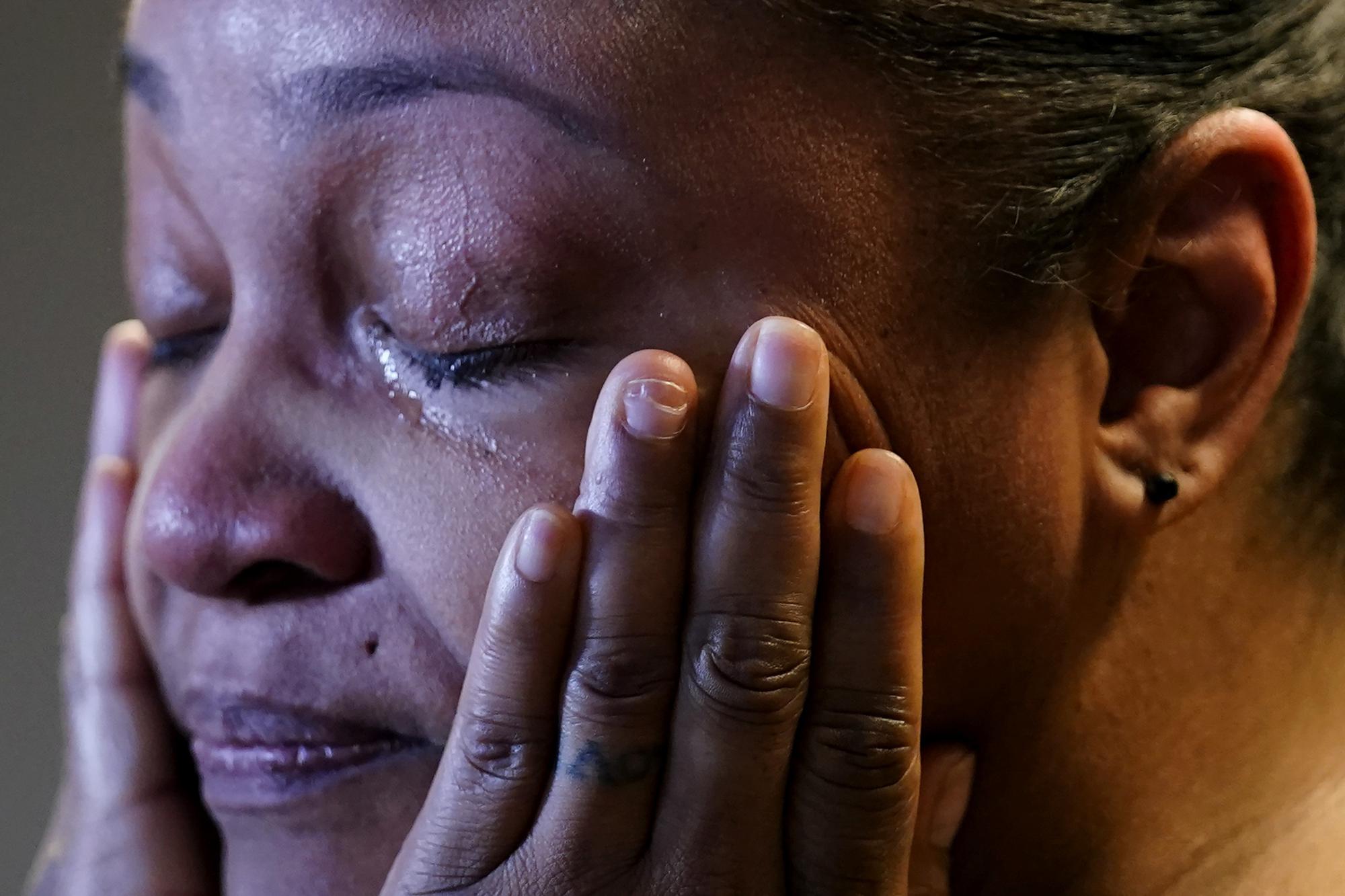In this Sept. 23, 2021, photo Krystal Archie cries while she talks with an Associated Press reporter at her attorney's office in Chicago. Archie’s three children were present when police, on two occasions, just 11 weeks apart, kicked open her front door executing a warrant as they were searching for drug suspects. She’d never heard of the people they were hunting. (AP Photo/Nam Y. Huh)