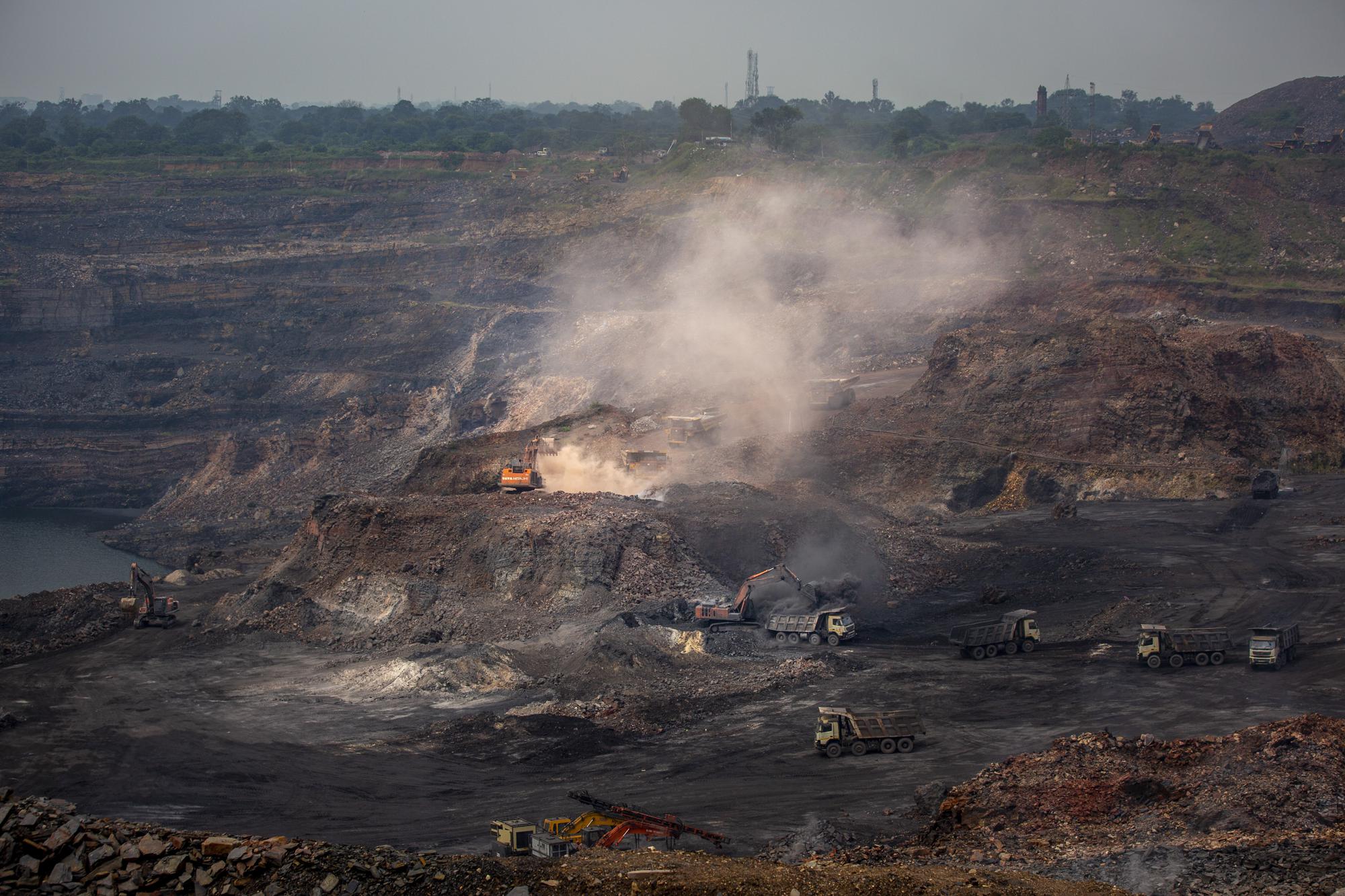 Mining is in progress at an open-cast mine near Dhanbad, an eastern Indian city in Jharkhand state, Friday, Sept. 24, 2021. Efforts to fight climate change are being held back in part because coal, the biggest single source of climate-changing gases, provides cheap electricity and supports millions of jobs. It's one of the dilemmas facing world leaders gathered in Glasgow, Scotland this week in an attempt to stave off the worst effects of climate change. (AP Photo/Altaf Qadri)
