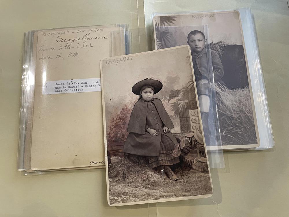 This July 8, 2021 image of photographs archived at the Center for Southwest Research at the University of New Mexico in Albuquerque, New Mexico, shows Indigenous students who attended the Ramona Industrial School in Santa Fe. The late 19th century images are among many in the Horatio Oliver Ladd Photograph Collection that are related to the boarding school. (AP Photo/Susan Montoya Bryan)