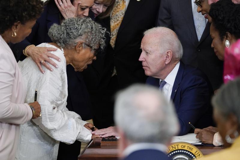 President Joe Biden speaks with Opal Lee after he signed the Juneteenth National Independence Day Act, in the East Room of the White House, Thursday, June 17, 2021, in Washington. (AP Photo/Evan Vucci)