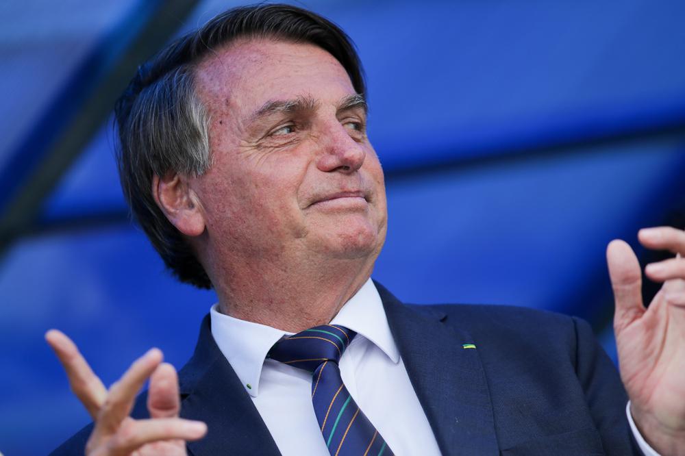 Brazilian President Jair Bolsonaro exits a convention center in Brasilia, Brazil, Tuesday, Nov. 30, 2021, after attending a ceremony where he officially joined the centrist Liberal Party. (AP Photo/Raul Spinasse)