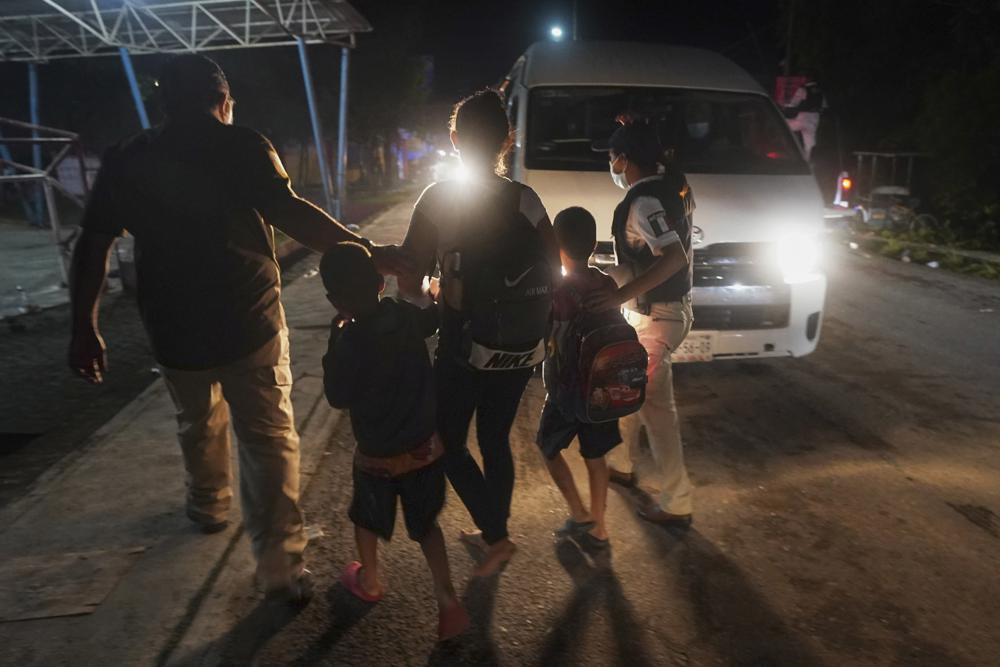 Mexican immigration agents detain a Central American migrant who is part of a caravan heading north in Huixtla, Chiapas state, Mexico, Sunday, Sept. 5, 2021. (AP Photo/Marco Ugarte)