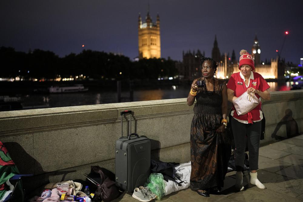 Grace, left, and Anne wait opposite the Palace of Westminster to be first in line to bid farewell to Queen Elizabeth II in London, September 12, 2022. (Photo: Markus Schreiber/AP)