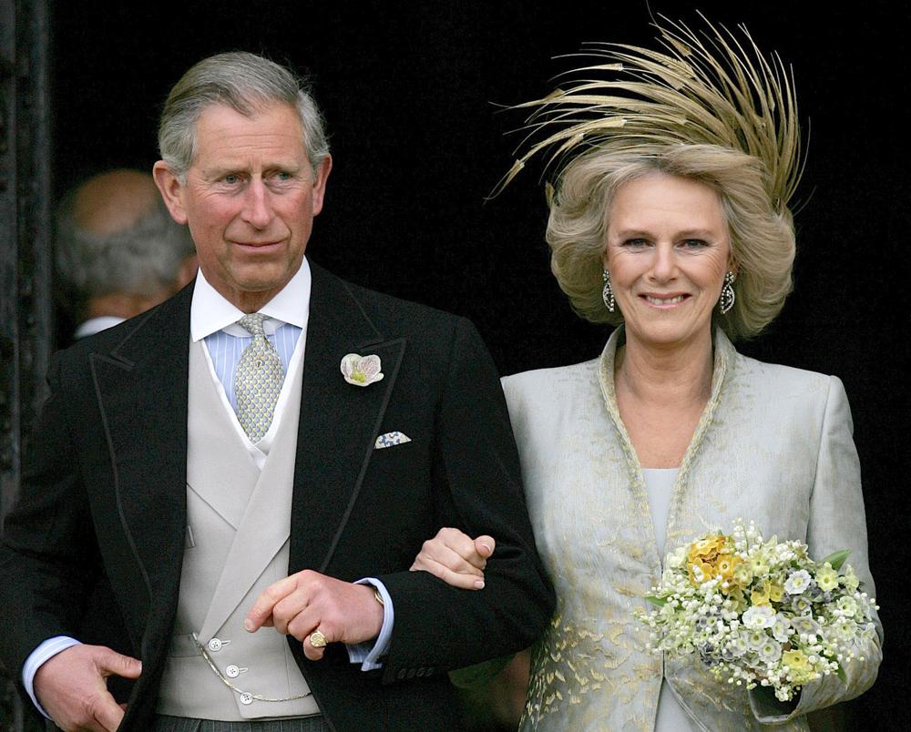 FILE - Britain's Prince Charles and his bride Camilla Duchess of Cornwall as they leave St George's Chaple in Windsor, England, April 9, 2005 following the church blessing of their civil wedding ceremony. Camilla, the Duchess of Cornwall, will celebrate her 75th birthday on  Sunday, July 17, 2022 marking the occasion with a small family dinner at Prince Charles’ Highgrove estate in southwest England. (AP Photo/ Alastair Grant, File)