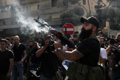 Un miliciano chií hace disparos al aire en el funeral de una de las personas caídas en el reciente brote de violencia en Beirut, Líbano, el 15 de octubre del 2021. (Foto AP/Bilal Hussein)