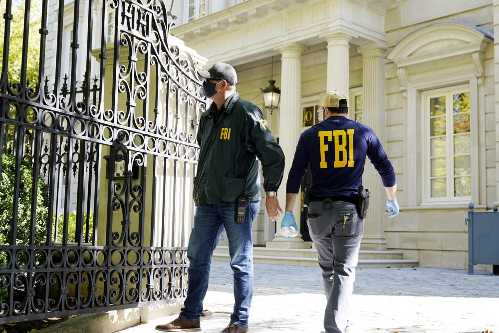 Federal agents stand in front of a home of Russian oligarch Oleg Deripaska, Tuesday, Oct. 19, 2021 in Washington. An agency spokesperson says FBI agents were at a home in Washington connected to Deripaska to carry out