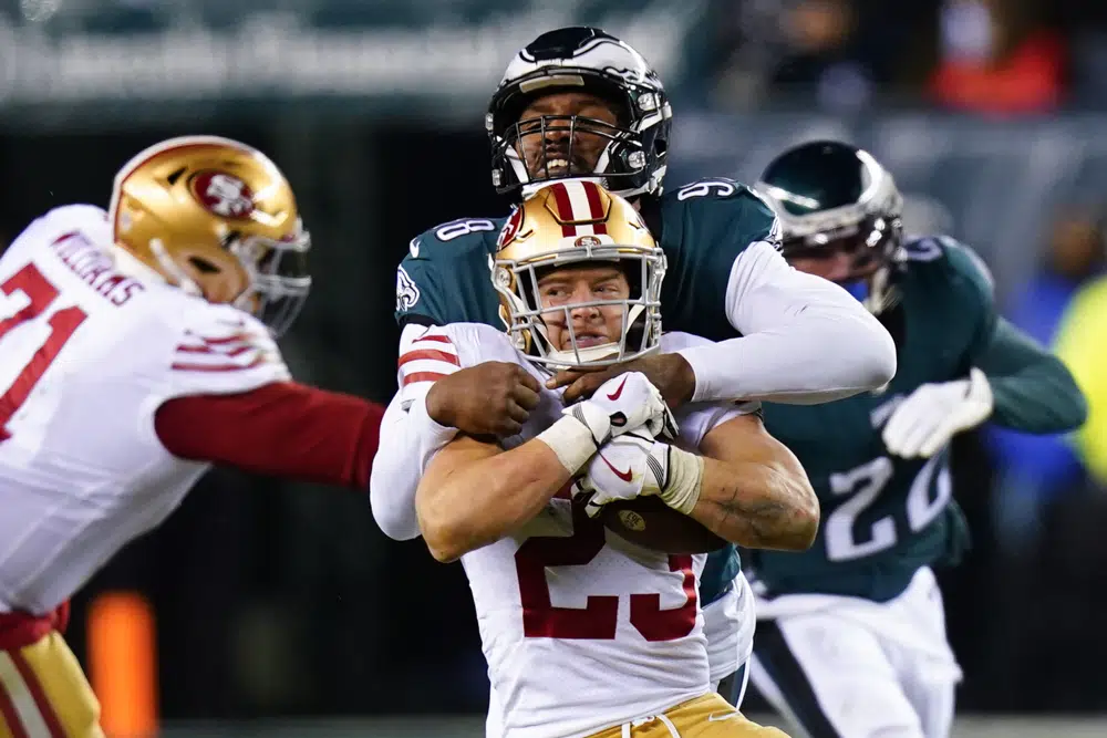 San Francisco 49ers running back Christian McCaffrey (23) is tackled by Philadelphia Eagles defensive end Robert Quinn during the second half of the NFC Championship NFL football game between the Philadelphia Eagles and the San Francisco 49ers on Sunday, Jan. 29, 2023, in Philadelphia. (AP Photo/Chris Szagola)