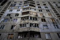 FILE - An apartment building damaged by a Russian attack in Saltivka district in Kharkiv, Ukraine, July 5, 2022. As Russia's invasion of Ukraine grinds into its fifth month, some residents close to the front lines remain in shattered and nearly abandoned neighborhoods. One such place is Kharkiv's neighborhood of Saltivka, once home to about half a million people. Only perhaps dozens live there now, in apartment blocks with no running water and little electricity. (AP Photo/Evgeniy Maloletka, File)