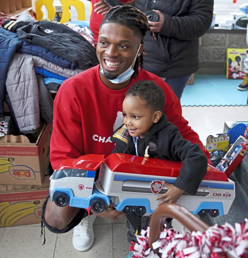 FILE - Pittsburgh NCAA college football defensive back Damar Hamlin poses for a photo with Bryce Williams, 3, of McKees Rocks, Pa., after the youngster picked out a toy during Hamlin's Chasing M's Foundation community toy drive at Kelly and Nina's Daycare Center, Tuesday, Dec. 22, 2020, in McKees Rocks, Pa. Hamlin wanted to raise $2,500 online to buy toys for needy kids. It took about two years. Then came Monday, Jan. 2, 2023, when the Buffalo Bills safety was critically injured during a game against the Cincinnati Bengals. He instantly became one of the biggest stories in sports, and thousands of people found his GoFundMe page. The result: Roughly $3.7 million donated in the first 12 hours. And the number is climbing. (Matt Freed/Pittsburgh Post-Gazette via AP, File, File)