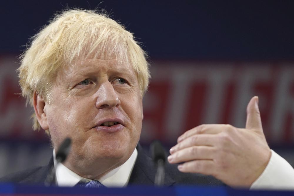 FILE - Britain's Prime Minister Boris Johnson gestures as he makes his keynote speech at the Conservative party conference in Manchester, England, Wednesday, Oct. 6, 2021. Britain agreed to a trade deal with New Zealand on Wednesday, Oct. 20, eliminating tariffs on a wide range of goods as the U.K. seeks to expand economic links around the world following its exit from the European Union. The deal was cemented in a conference call between Johnson and his New Zealand counterpart, Jacinda Ardern, after 16 months of talks by negotiators. (AP Photo/Jon Super, File)