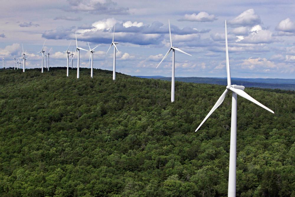 FILE - Wind turbines line a ridge on Stetson Mountain, July 14, 2009, in Washington County, Maine. Massachusetts and Maine are collaborating on a plan to finance an inland wind power project in far northern Maine. (AP Photo/Robert F. Bukaty, File)