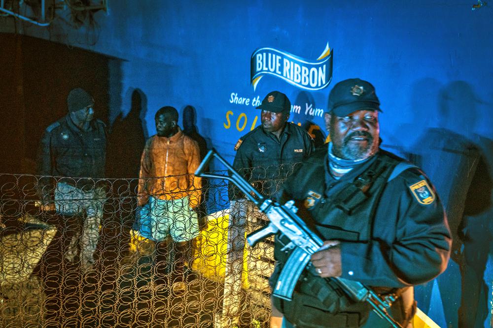 Police patrol an area in Soweto, South Africa Tuesday, July 12, 2022 in search of illegal firearms following the weekend shooting in a bar which claimed 16 people. South African police are searching for illegally-held guns in patrols of Johannesburg's Soweto township, following a spate of bar shootings that have rocked the nation. (AP Photo/Shiraaz Mohamed)