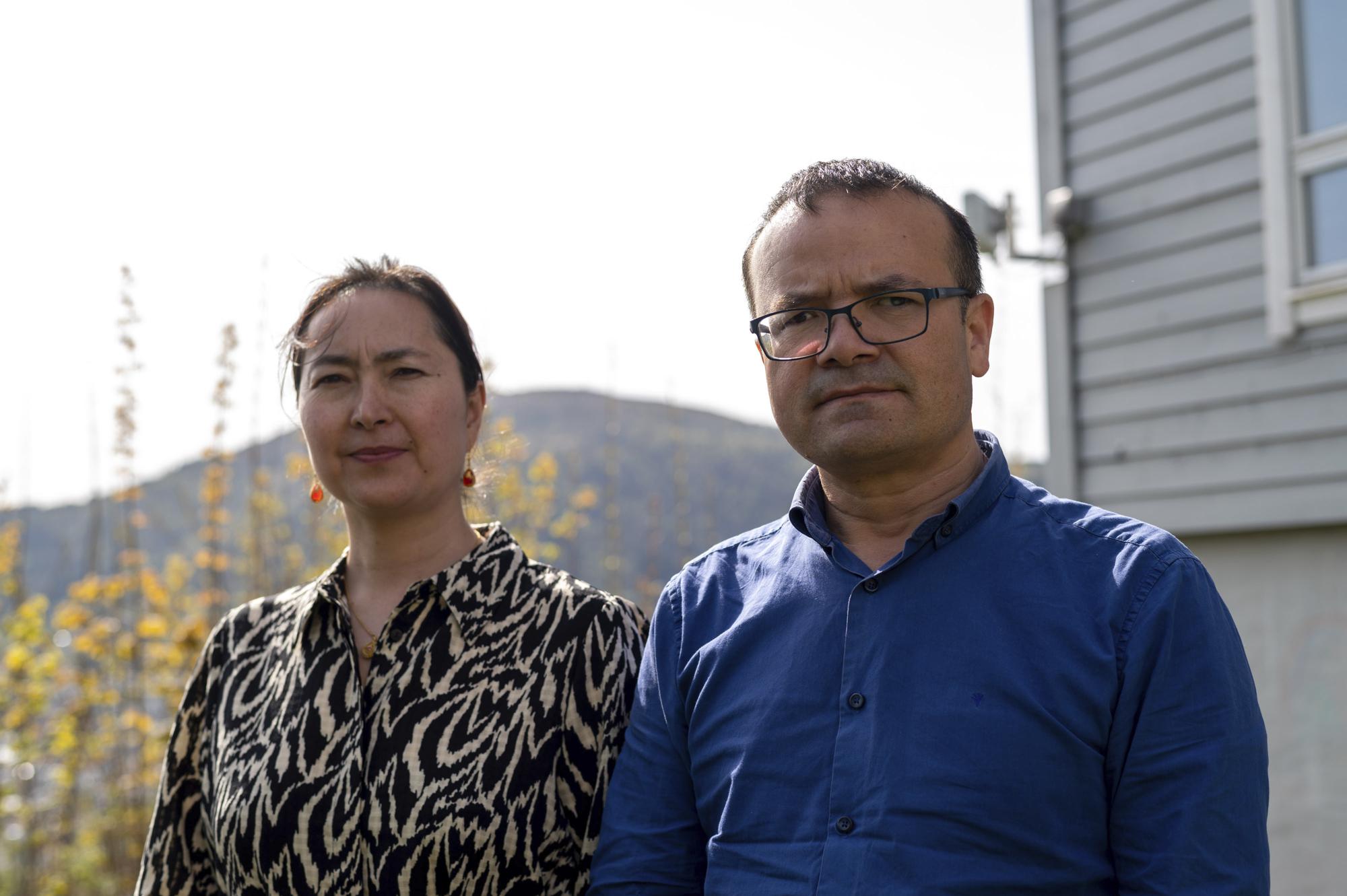 Uyghur couple Mihrigul Musa, left, and Abduweli Ayup pose for a photograph in their yard in Bergen, Norway on May 8, 2022. Nearly one in 25 people in a county in the Uyghur heartland of China has been sentenced to prison on terrorism-related charges, in what is the highest known imprisonment rate in the world, an Associated Press review of leaked data shows. Ayup and Musa knew friends and relatives sentenced to prison according to the list. (AP Photo/Paul Johannessen)