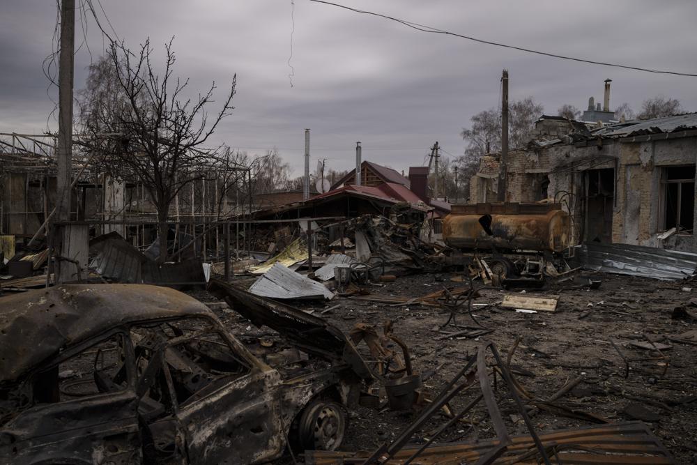 Destroyed vehicles and buildings are seen in the town of Trostsyanets, Ukraine, Monday, March 28, 2022. Trostsyanets was recently retaken by Ukrainian forces after being held by Russians since the early days of the war. (AP Photo/Felipe Dana)