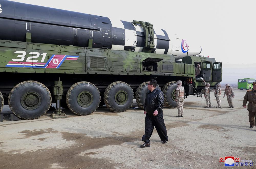 In this photo distributed by the North Korean government, North Korean leader Kim Jong Un, center, walks around what it says a Hwasong-17 intercontinental ballistic missile (ICBM) on the launcher, at an undisclosed location in North Korea on March 24, 2022. Independent journalists were not given access to cover the event depicted in this image distributed by the North Korean government. The content of this image is as provided and cannot be independently verified. Korean language watermark on image as provided by source reads: "KCNA" which is the abbreviation for Korean Central News Agency. (Korean Central News Agency/Korea News Service via AP)