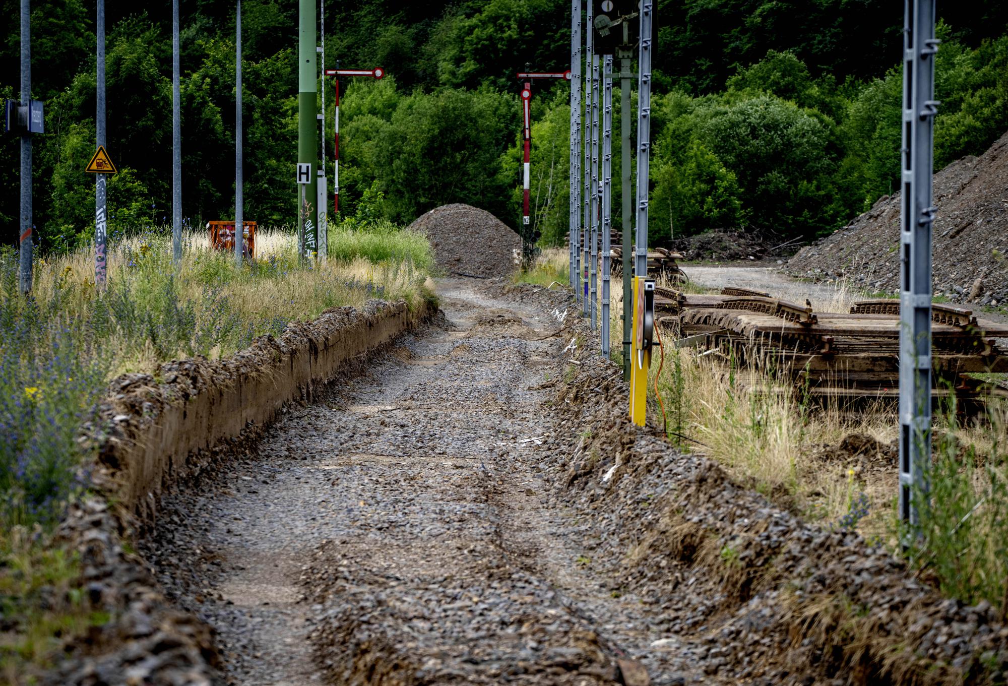 Rails damaged by last year's flood lie next to an empty track bed in Kreuzberg in the Ahrtal valley, Germany, Tuesday, July 6, 2022. Flooding caused by heavy rain hit the region on July 14, 2021, causing the death of about 130 people. (AP Photo/Michael Probst)