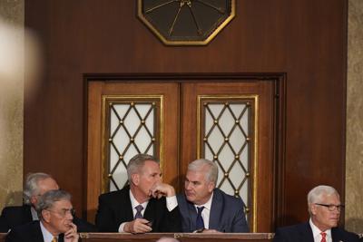 Rep. Kevin McCarthy, R-Calif., talks to Rep. Tom Emmer, R-Minn., during a sixth round of voting in the House chamber as the House meets for a second day to elect a speaker and convene the 118th Congress in Washington, Wednesday, Jan. 4, 2023. (AP Photo/Alex Brandon)