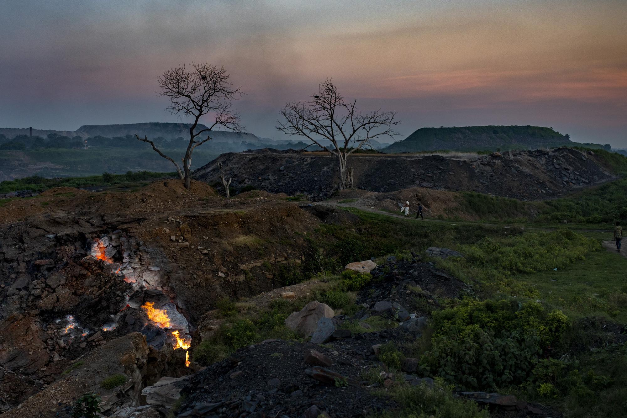 Flames rise out of the fissures in the ground above coal mines in the village of Liloripathra near Dhanbad, an eastern Indian city in Jharkhand state, Friday, Sept. 24, 2021. A 2021 Indian government study found that Jharkhand state -- among the poorest in India and the state with the nation’s largest coal reserves -- is also the most vulnerable Indian state to climate change. Efforts to fight climate change are being held back in part because coal, the biggest single source of climate-changing gases, provides cheap electricity and supports millions of jobs. It's one of the dilemmas facing world leaders gathered in Glasgow, Scotland this week in an attempt to stave off the worst effects of climate change. (AP Photo/Altaf Qadri)