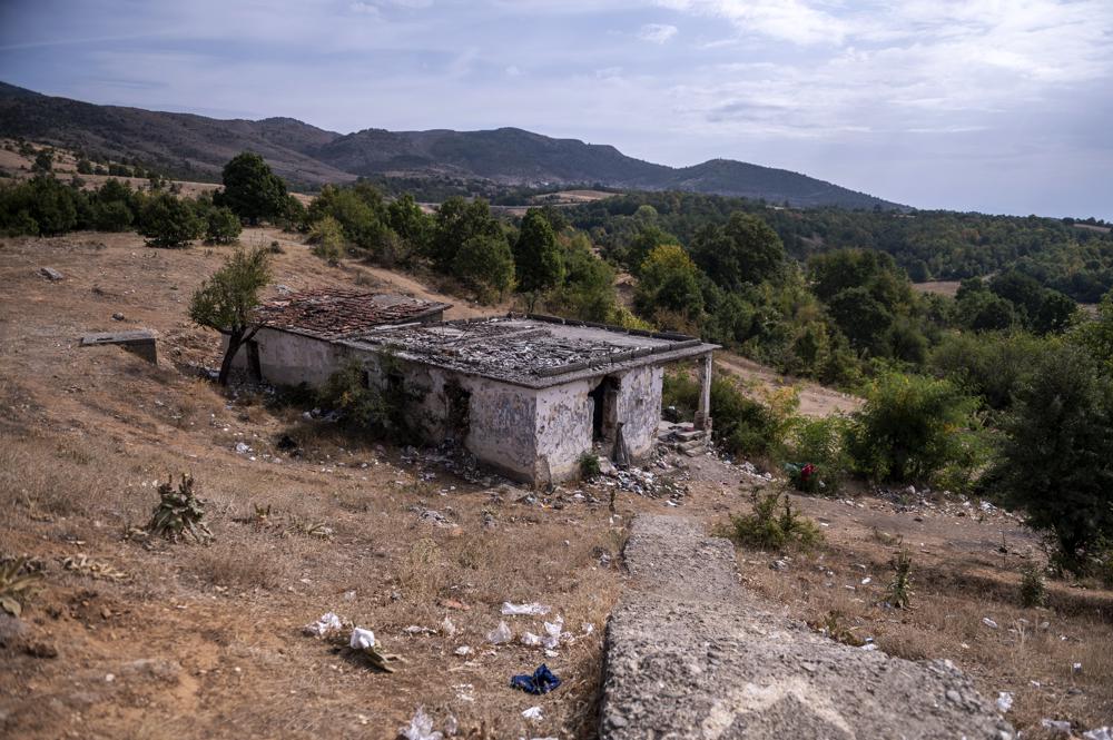 An abandoned army outpost where migrants gather near Ieropigi village, northern Greece, at the Greek - Albanian border, on Tuesday, Sept. 28, 2021. A relatively smooth section of Greece's rugged border with Albania is turning into a major thoroughfare north for migrants in Greece seeking a better life in Europe's prosperous heartland. (AP Photo/Giannis Papanikos)