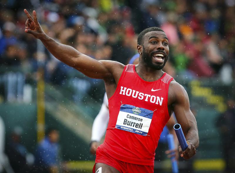 FILE - In this June 8, 2018 file photo, Houston's Cameron Burrell raises two fingers to indicate Houston's back-to-back men's 400-meter relay wins, during the third day of the NCAA Outdoor Track and Field Championships at Hayward Field in Eugene, Ore. Burrell, the former NCAA national champion sprinter died on Monday, Aug. 9, 2021 according to the University of Houston, where he starred from 2013-2018. (Andy Nelson/The Register-Guard via AP, File)