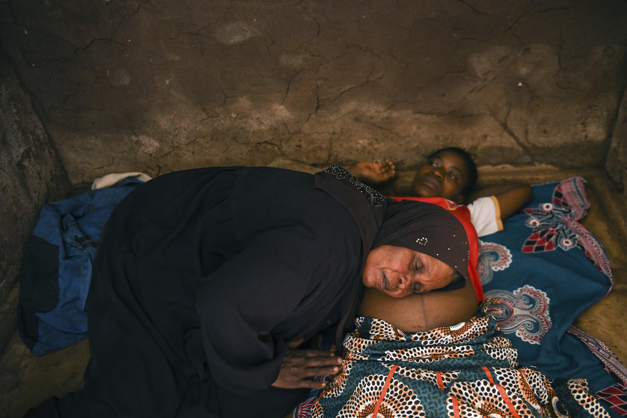 Lucy Mbewe, a traditional birth attendant listens to an unborn baby's heartbeat at her home, in Simika Village, Chiradzulu, southern Malawi on Sunday, May 23, 2021. Health officials in Malawi say fewer women are getting prenatal care amid the COVID-19 pandemic. At risk are the developing country's gains on its poor rate of maternal deaths. (AP Photo/Thoko Chikondi)