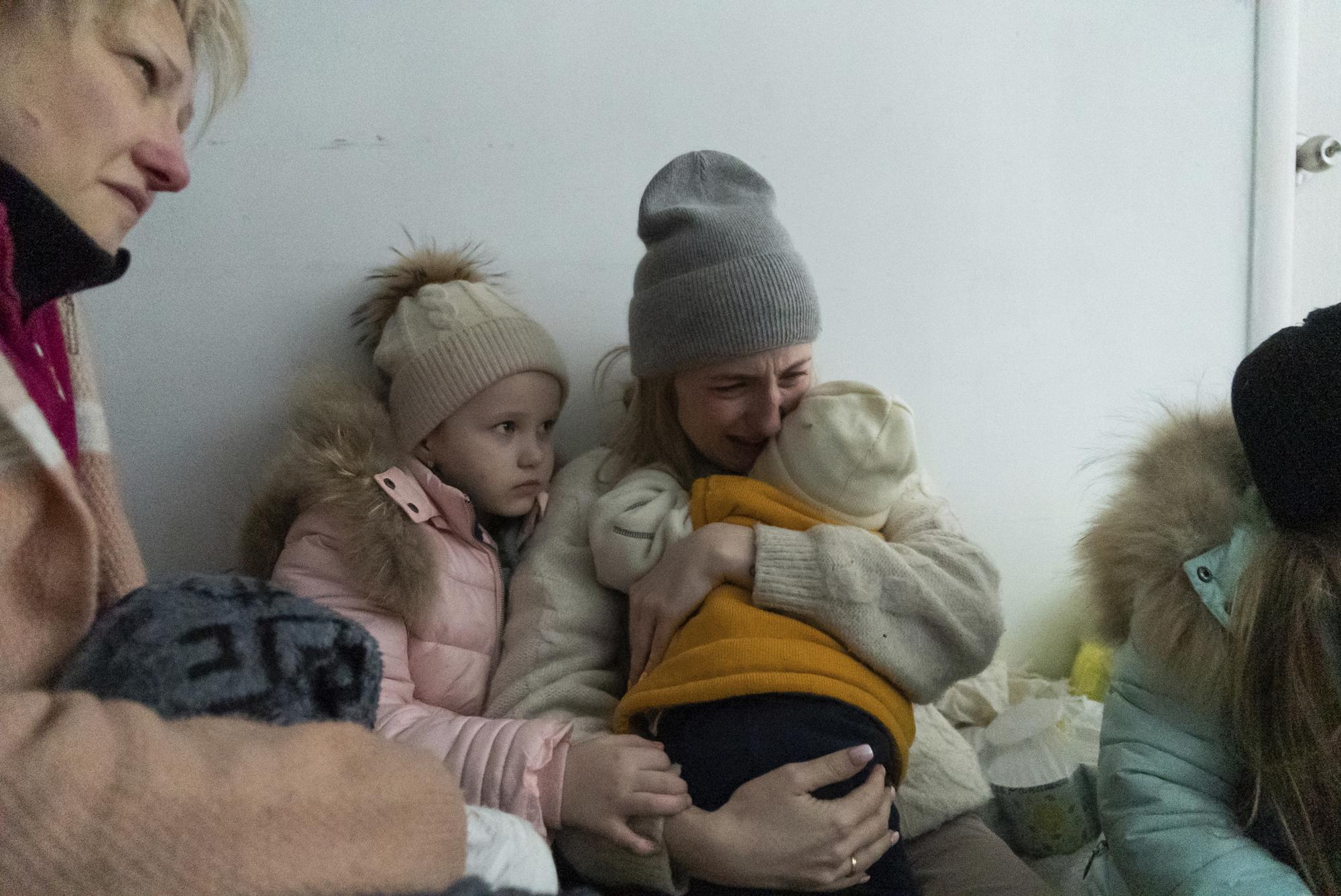 A woman whose husband was killed in the shelling cries on the floor of a corridor in a hospital in Mariupol, eastern Ukraine Friday, March 11, 2022. (AP Photo/Mstyslav Chernov)