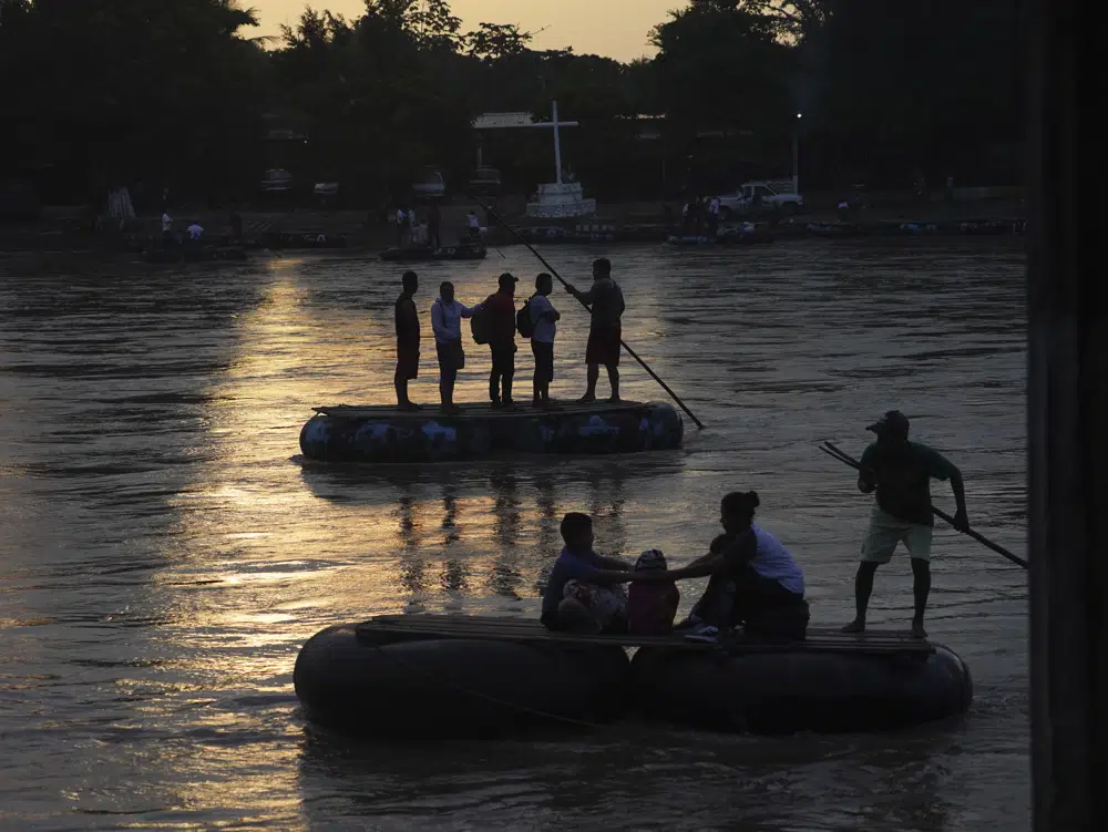 Migrantes venezolanos cruzan el río Suchiate en la frontera entre Guatemala y México, cerca de Ciudad Hidalgo, estado de Chiapas, México, el martes 4 de octubre de 2022. Las autoridades dan a muchos migrantes órdenes de expulsión pero también les dicen que pueden cambiar esos documentos por permisos de tránsito, popularmente llamados "salvoconductos". (AP Foto/Marco Ugarte)