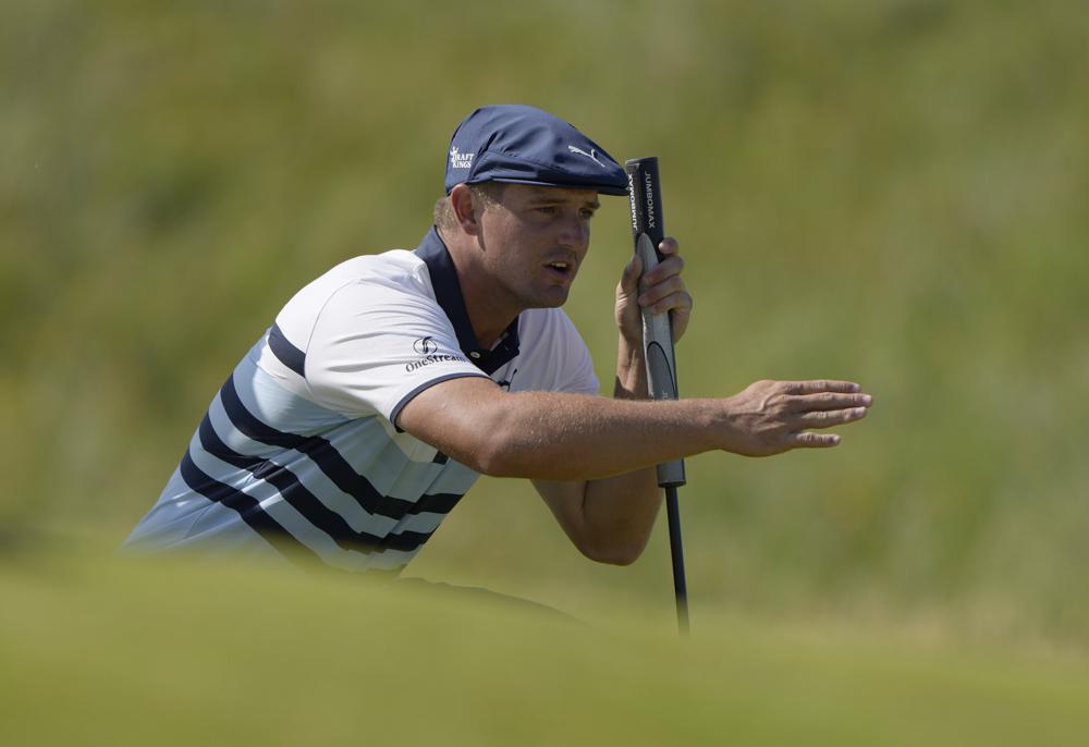 FILE - In this July 17, 2021, file photo, United States' Bryson DeChambeau gestures as he lines up his putt on the 2nd green during the third round of the British Open Golf Championship at Royal St George's golf course Sandwich, England. DeChambeau has tested positive for COVID-19 before leaving the United States for the Olympics and will miss the Tokyo Games. He’ll be replaced by Patrick Reed.  (AP Photo/Alastair Grant, File)