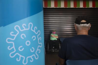 Gente descansando tras recibir una tercera dosis de la vacuna de Pfizer-BioNTech contra el COVID-19 en un centro de vacunación en Tel Aviv, Israel, el martes 10 de agosto de 2021. (AP foto/Oded Balilty)