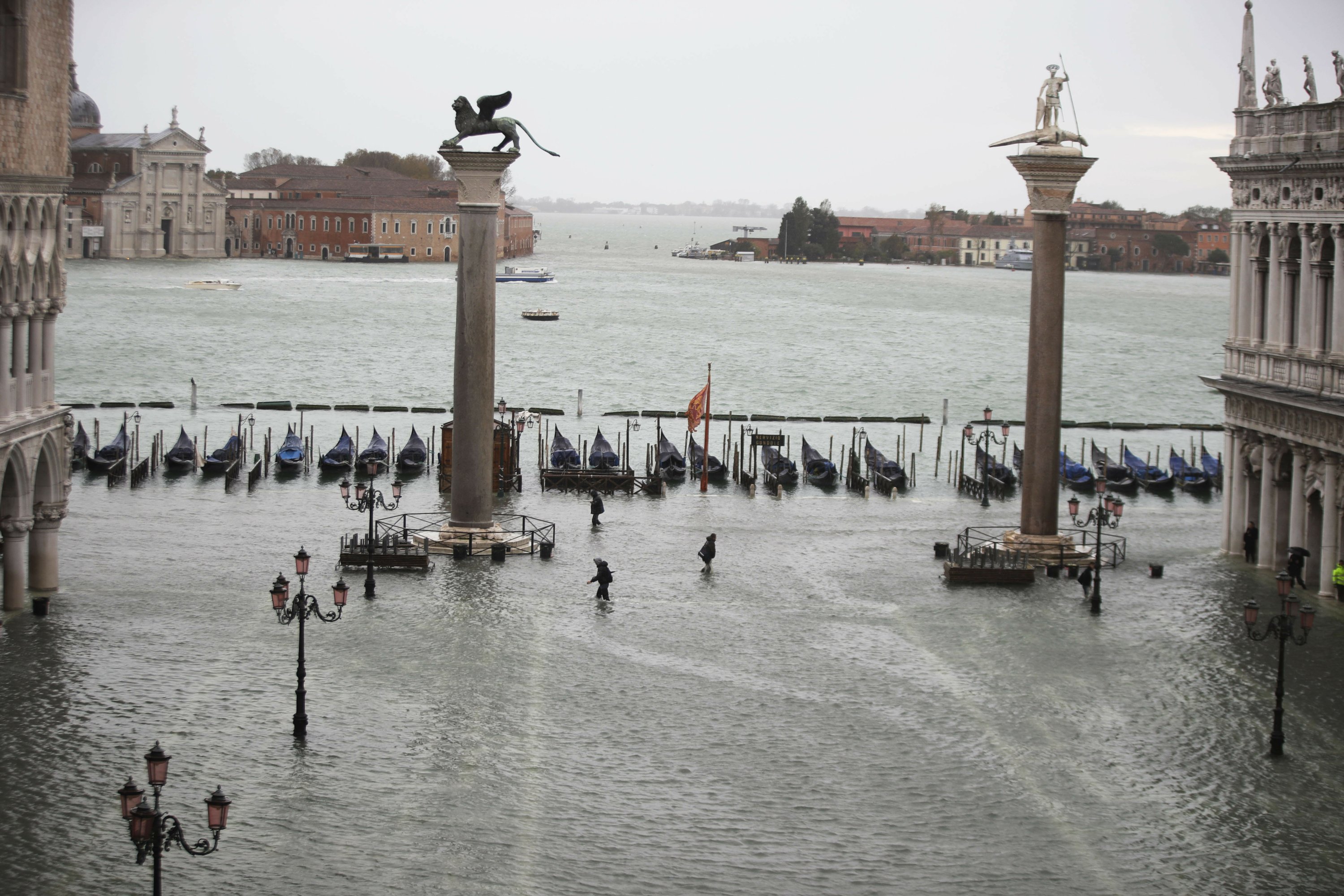 High tides surge through Venice, locals rush to protect art