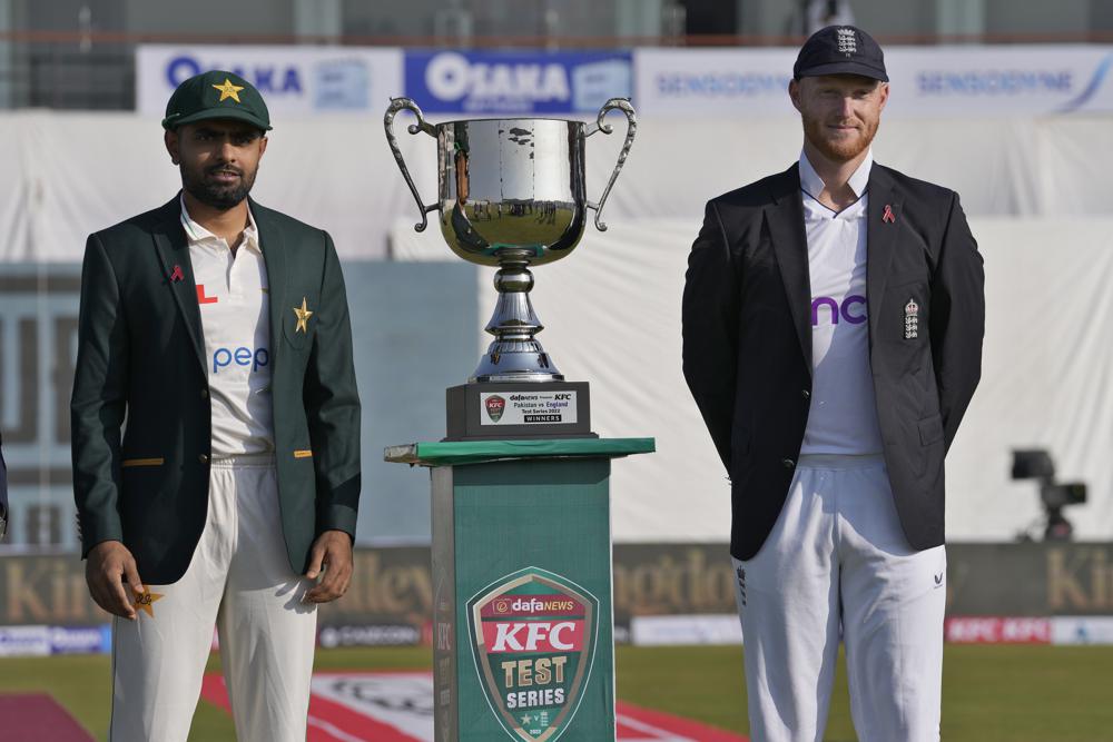 England's skipper Ben Stokes, right, and his Pakistani counterpart Babar Azam pose for photograph with test-series trophy prior to start of first cricket test match between Pakistan and England, in Rawalpindi, Pakistan, Dec. 1, 2022. (AP Photo/Anjum Naveed)