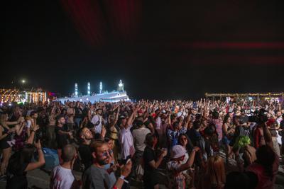 Music fans flock to Albania's beach festival despite virus | AP News