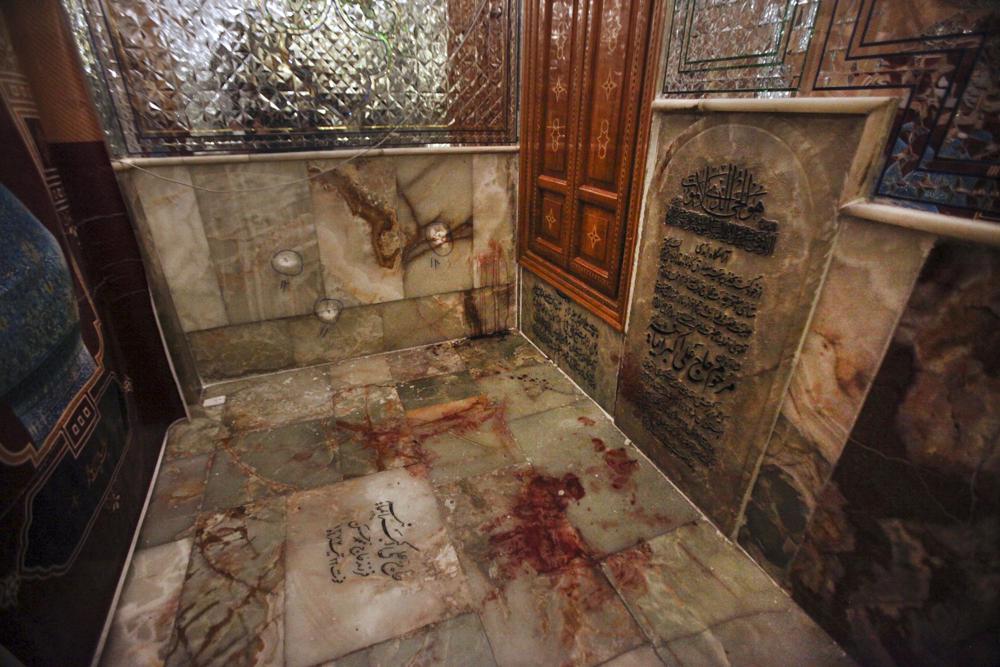 Bullet holes on the wall and blood on the ground are seen after gunmen attacked the Shah Cheragh shrine in the southern city of Shiraz, Iran, Wednesday, Oct. 26, 2022. Gunmen attacked the major Shiite holy site in Iran on Wednesday, killing at least 15 people and wounding dozens. The attack came as protesters elsewhere in Iran marked a symbolic 40 days since a woman's death in custody ignited the biggest anti-government movement in over a decade. (Mohammadreza Dehdari/Iranian Students' News Agency, ISNA via AP)