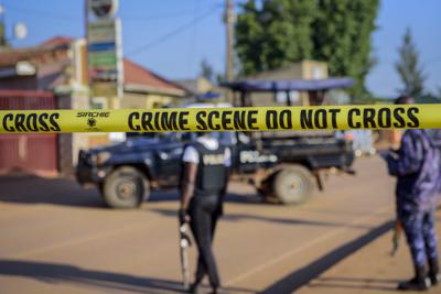 Policías aseguran una calle que lleva a la escena de una explosión en el suburbio de Komamboga, en Kampala, la capital de Uganda, el domingo 24 de octubre de 2021. (AP Foto/Nicholas Bamulanzeki)