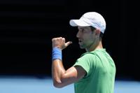 Defending men's champion Serbia's Novak Djokovic gestures during a practice session on Margaret Court Arena ahead of the Australian Open tennis championship in Melbourne, Australia, Thursday, Jan. 13, 2022. AP Photo/Mark Baker)