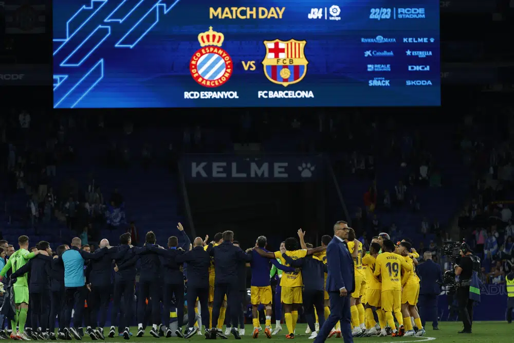 Barcelona players celebrate after the Spanish La Liga soccer match between Espanyol and Barcelona at the RCDE stadium in Barcelona, Sunday, May 14, 2023. (AP Photo/Joan Monfort)
