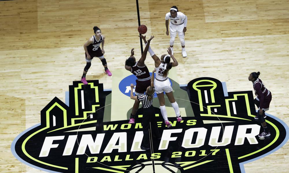 FILE - Mississippi State center Teaira McCowan (15) and South Carolina forward A'ja Wilson (22) reach for the ball on the opening tipoff of the final of the NCAA women's college basketball tournament Final Four, Sunday, April 2, 2017, in Dallas. The NCAA women's basketball title game will be broadcast on ABC for the first time this season. The championship game, which usually airs in primetime, will be played at 3 p.m. ET. The Final Four is in Dallas this year. (AP Photo/Eric Gay, File)