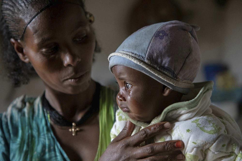 Mother Ababa, 25, comforts her baby Wegahta, 6 months, who was identified as severely acutely malnourished, in Gijet in the Tigray region of northern Ethiopia Tuesday, July 20, 2021. For months, the United Nations has warned of famine in Tigray and now internal documents and witness accounts reveal the first starvation deaths since Ethiopia's government in June imposed what the U.N. calls "a de facto humanitarian aid blockade." (Christine Nesbitt/UNICEF via AP)