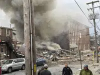 Emergency personnel work at the site of a deadly explosion at a chocolate factory in West Reading, Pa., Friday, March 24, 2023. ( Ben Hasty /Reading Eagle via AP)