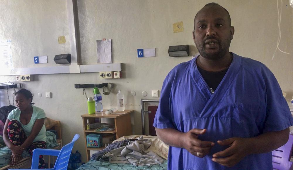 In this image made from video provided anonymously, nurse Tekleab explains the situation in the malnutrition ward of the Ayder Referral Hospital in Mekele, in the Tigray region of northern Ethiopia, Tuesday, Sept. 28, 2021. In the regional capital Mekele, a year of war and months of government-enforced deprivation have left the city of a half-million people with a rapidly shrinking stock of food, fuel, medicine and cash. (AP Photo)