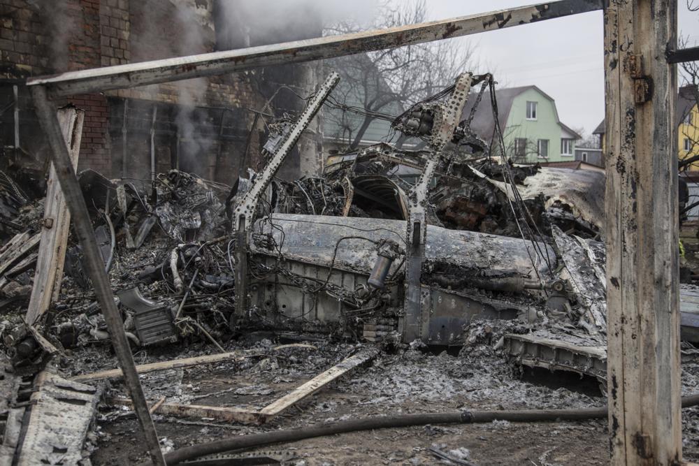 Fragments of a downed aircraft are seen in in Kyiv, Ukraine, Friday, Feb. 25, 2022. It was unclear whose aircraft crashed and who brought it down amid the Russian invasion in Ukraine. Russia is pressing its invasion of Ukraine to the outskirts of the capital after unleashing airstrikes on cities and military bases and sending in troops and tanks from three sides. (AP Photo/Oleksandr Ratushniak)