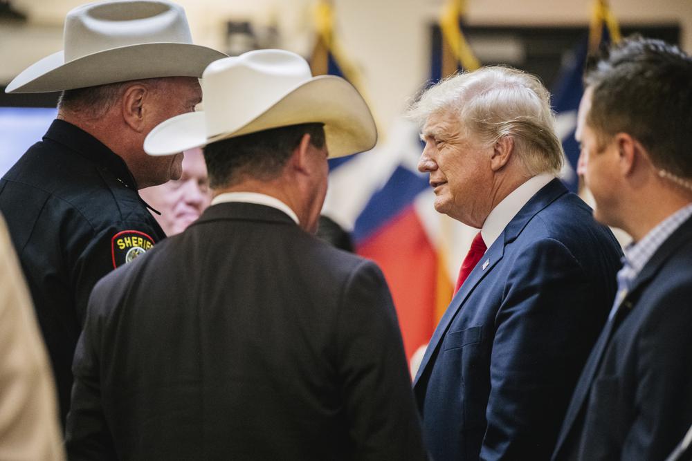 TRUMP AT THE BORDER 3 Former President Donald Trump greets law enforcement while arriving at a border security briefing to discuss further plans in securing the southern border wall on Wednesday, June 30, 2021, in Weslaco, Texas. (Brandon Bell/Pool via AP)