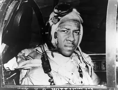 FILE - This circa 1950 photo provided by the U.S. Navy shows Jesse Brown in the cockpit of an F4U-4 Corsair fighter at an unidentified location. In December 2022, FedEx founder Fred Smith gifted the proceeds from the film “Devotion,” which he financed, that tells the story of groundbreaking Naval aviators Brown and Thomas Hudner. The proceeds will fund in part scholarships for the children of Navy service members studying STEM. (U.S Navy via AP, File)