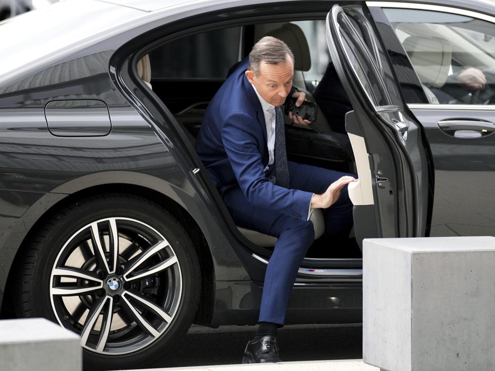 FILE - Volker Wissing, now Federal Minister for Digital Affairs and Transport, arrives in a BMW car in Berlin, Germany, Thursday, Oct. 21, 2021. Germany's transport minister said Thursday that he opposes plans to ban the sale of new cars with combustion engines across the European Union in 2035, arguing this would discriminate against vehicles powered with synthetic fuels. EU lawmakers voted Wednesday to back the measure that requires automakers to cut carbon-dioxide emissions by 100% by the middle of the next decade, effectively prohibiting the sale in the 27-nation bloc of new cars powered by gasoline or diesel. (AP Photo/Michael Sohn, File)