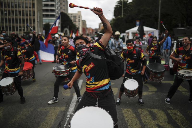 Young men perform in a drumline during an anti-government protest in Bogota, Colombia, Tuesday, July 20, 2021, as the county marks its Independence Day. (AP Photo/Ivan Valencia)