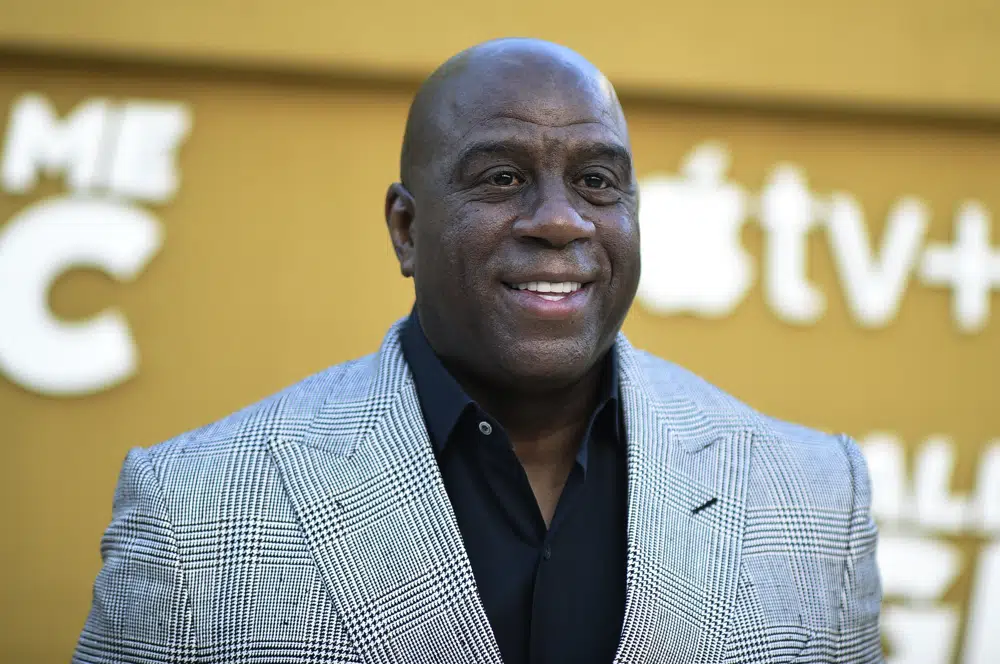 FILE - Magic Johnson arrives at the premiere of "They Call Me Magic" on Thursday, April 14, 2022, at Regency Village Theatre in Los Angeles. A group led by Josh Harris and Mitchell Rales that includes Magic Johnson has an agreement in principle to buy the NFL's Washington Commanders from longtime owner Dan Snyder for a North American professional sports team record $6 billion, according to a person with knowledge of the situation. The person spoke to The Associated Press on condition of anonymity Thursday, April 13, 2023, because the deal had not been announced. (Photo by Richard Shotwell/Invision/AP, File)