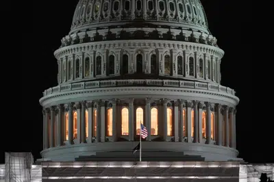 The American flags flies on the U.S. Capitol before sunrise on the the second year anniversary of the violent insurrection by supporters of then-President Donald Trump, in Washington, Friday, Jan. 6, 2023. (AP Photo/Matt Rourke)