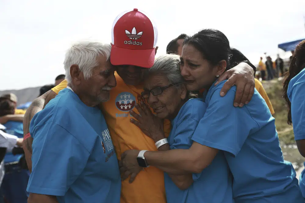 People living in the U.S. embrace with people living in Mexico during the 10th annual "Hugs not Walls" event, on a stretch of the Rio Grande, in Ciudad Juarez, Mexico, Saturday, May 6, 2023. The brief family reunions are part of a campaign sponsored by the Border Network for Human Rights, an immigration rights group. (AP Photo/Christian Chavez)